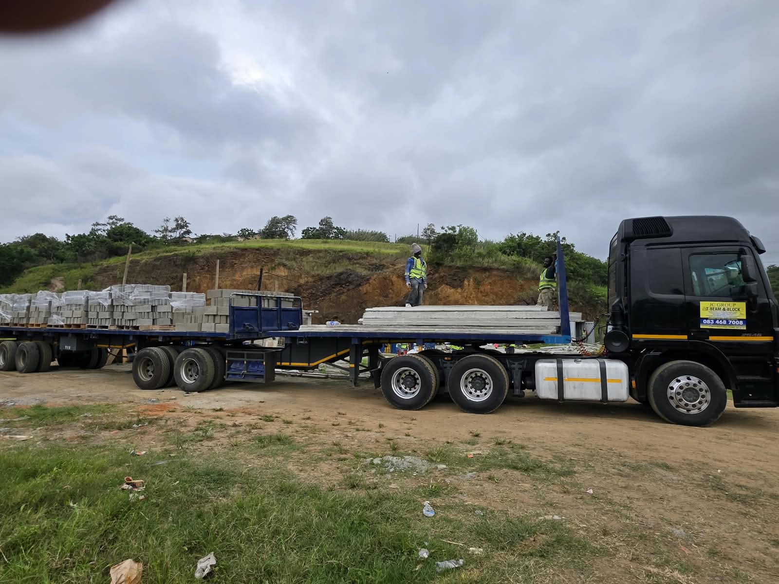 JC Group truck delivering precast beams and blocks